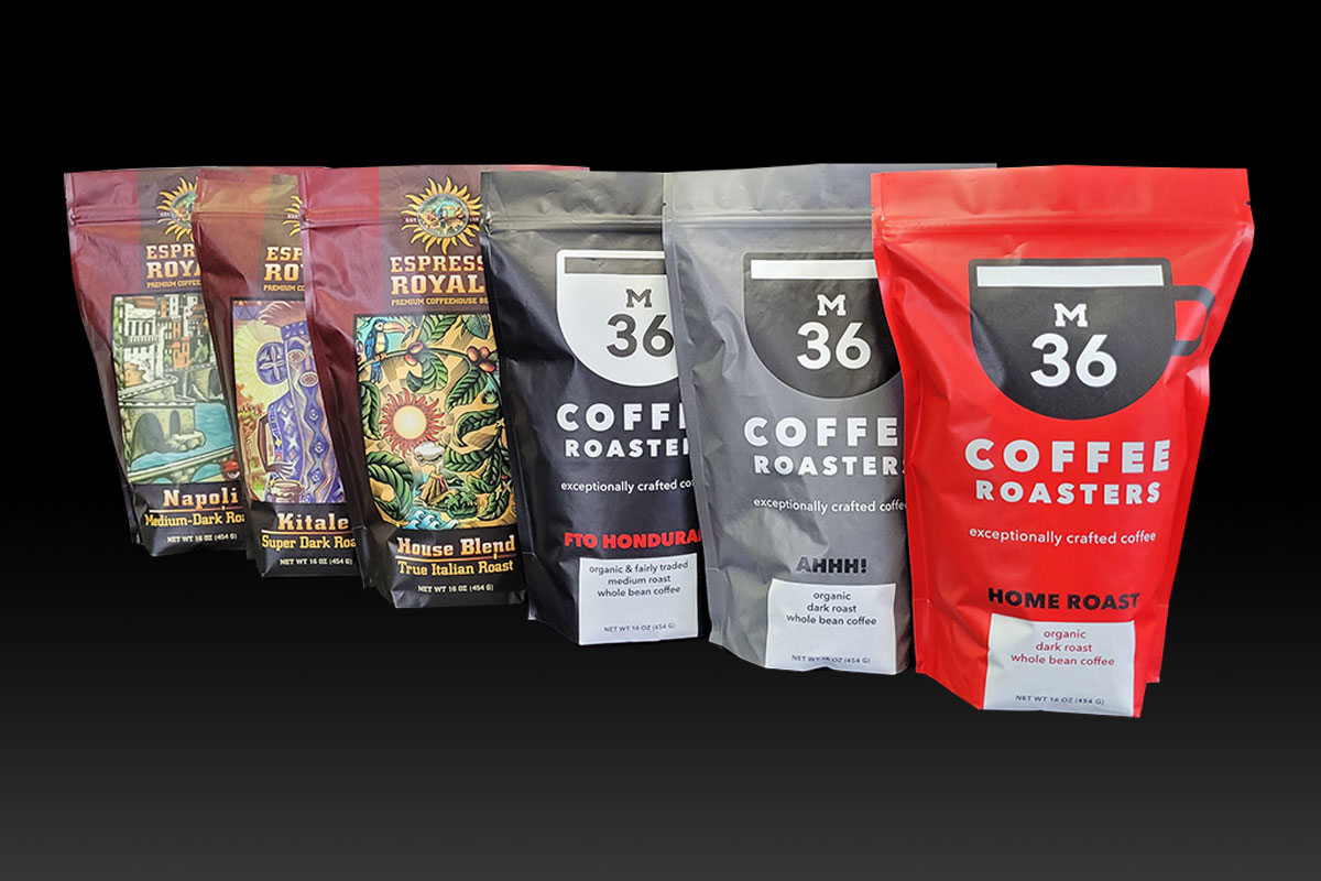 3 bags of Espresso Royale coffee and 3 bags of M36 coffee on a black background